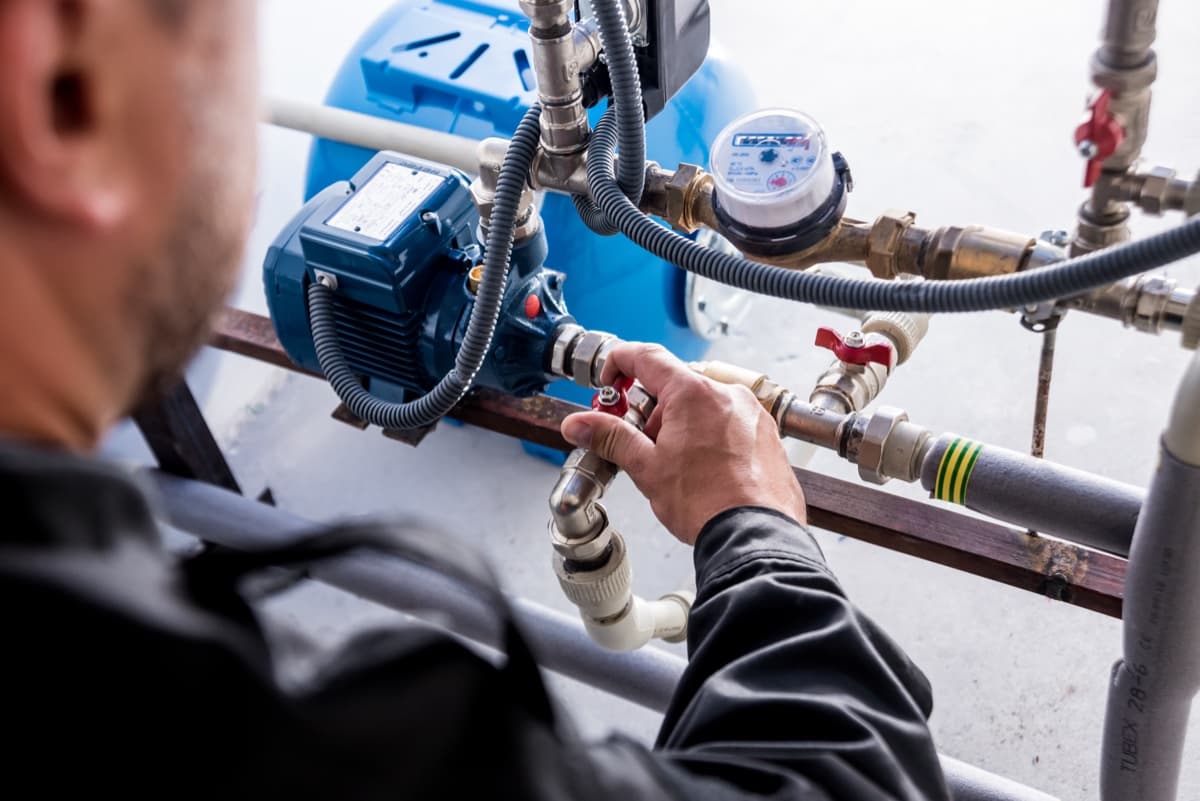 Technician installing water system